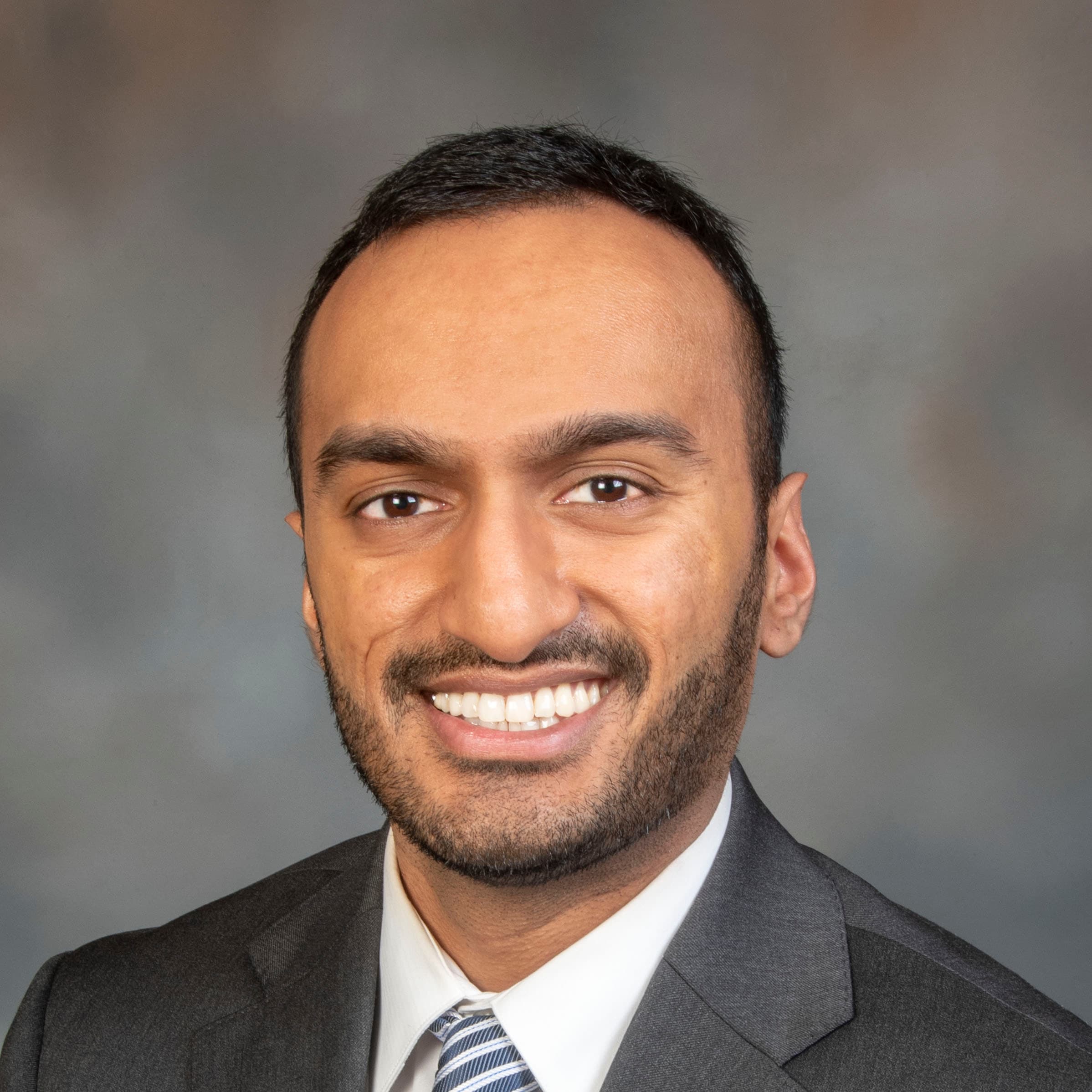 Close-up portrait of Dr. Arpeet Patel, smiling warmly.